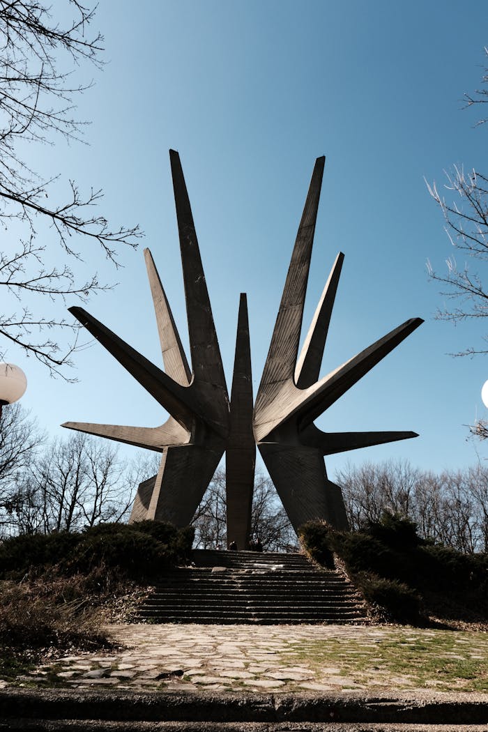 Dramatic view of the Kosmaj Memorial Complex against a clear blue sky in Rogača, Serbia.